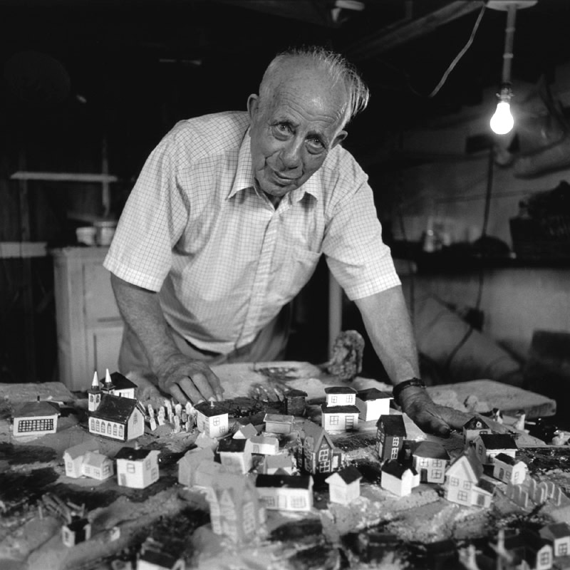 Portrait of Reg Feltham with his model of Deer Island, Bonavista Bay
