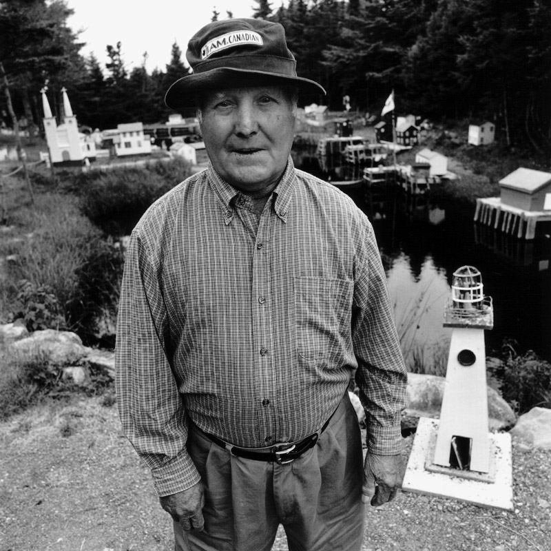Portrait of Frank Mullett with his model of Oderin, Placentia Bay